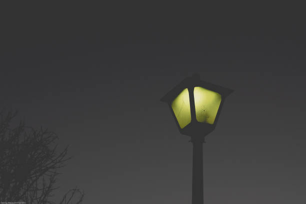 istock Yellow Glowing Street Lamp Against Black Sky 1132604862