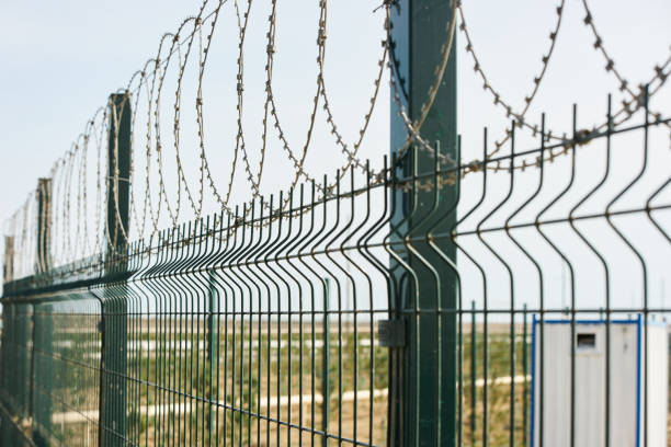istock Barbed wire against cloudy sky, close-up outdoors 1132609080