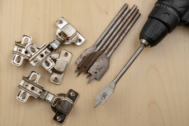 istock Drilling with a vane drill in chipboard. Carpentry work in a carpentry workshop. Light background. 1132610110