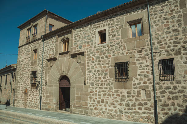 istock Empty alley and gothic building with large door at Avila 1132610343