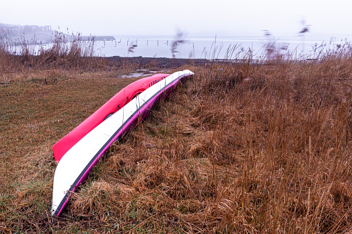 Two canoes on shore during winter