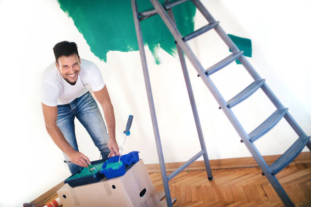 istock Handsome guy painting walls at his home. 1132613828
