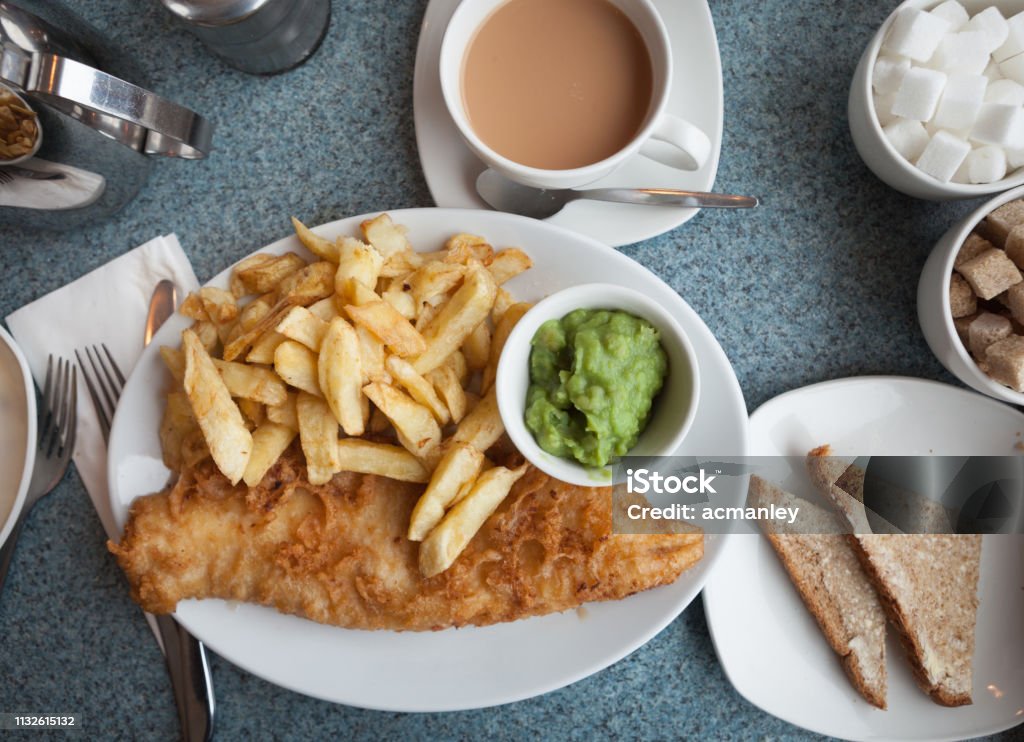 Fish and chips with mushy peas. Traditional British fish and chips with mushy peas. Fish and Chips Stock Photo