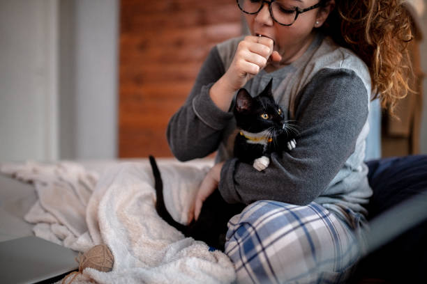 istock Young woman playing on the bed with her cat 1132615693
