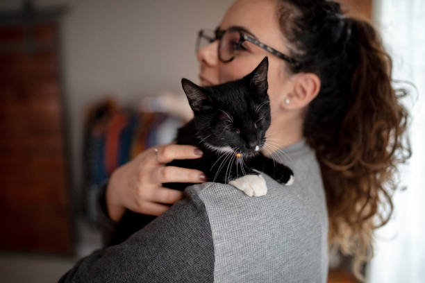 istock Young woman holding cat 1132615836