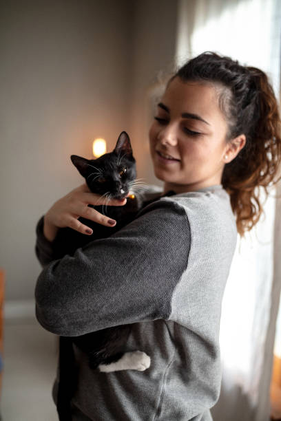 istock Young woman holding cat 1132615866