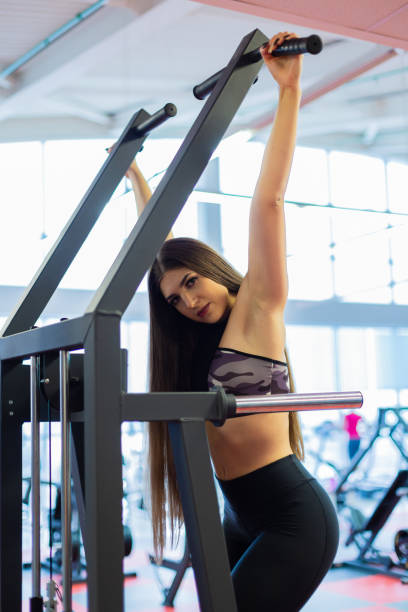 istock Young woman training in the gym. Pulling in gravitrone 1132616159