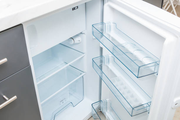 istock Empty opened refrigerator with clean glass shelves. Close up. 1132617251