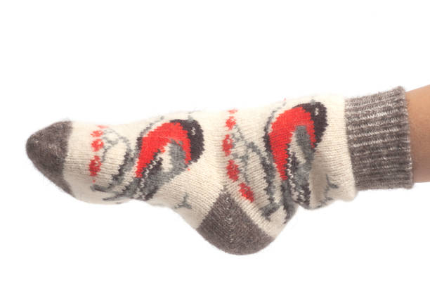 istock Wool socks on woman's feet isolated on white background 1132619496