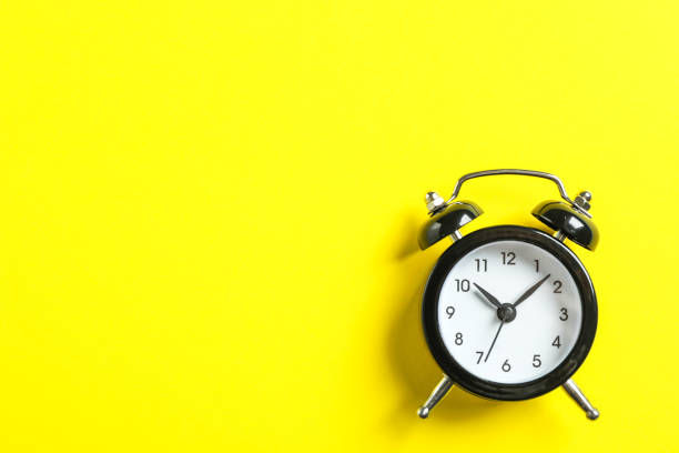 istock Retro alarm clock on color background, space for text 1132620400
