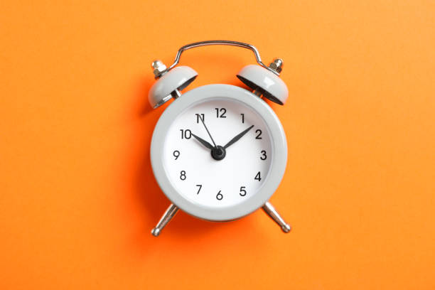 istock Retro alarm clock on color background, space for text 1132620417
