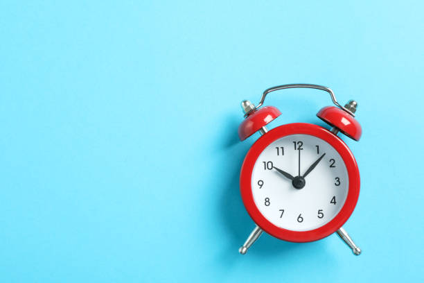 istock Retro alarm clock on color background, space for text 1132620450