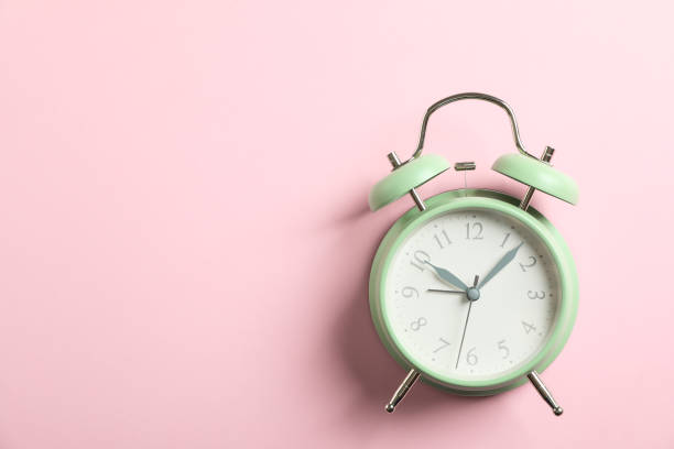 istock Retro alarm clock on color background, space for text 1132620463