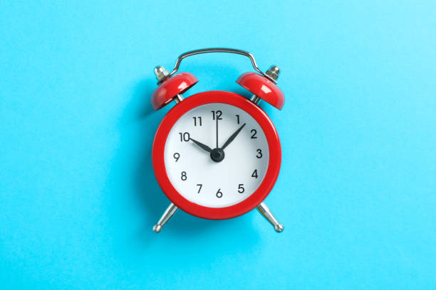 istock Retro alarm clock on color background, space for text 1132620480