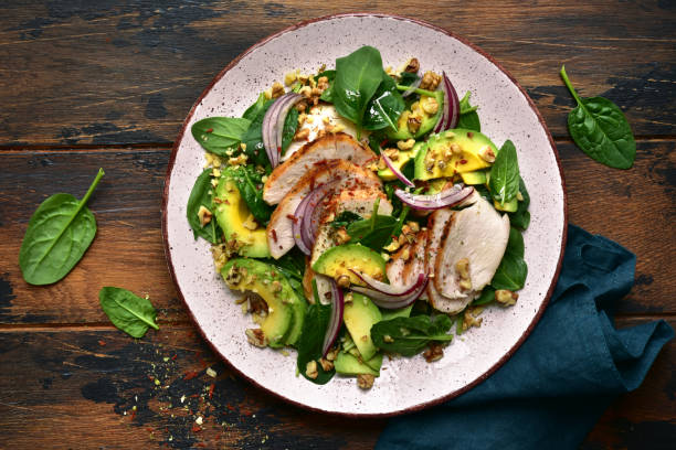 istock Spinach salad with grilled chicken fillet, avocado and walnuts 1132622138