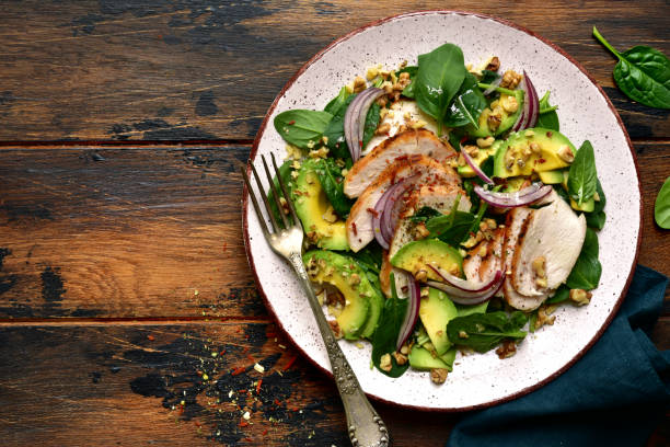 istock Spinach salad with grilled chicken fillet, avocado and walnuts 1132622229