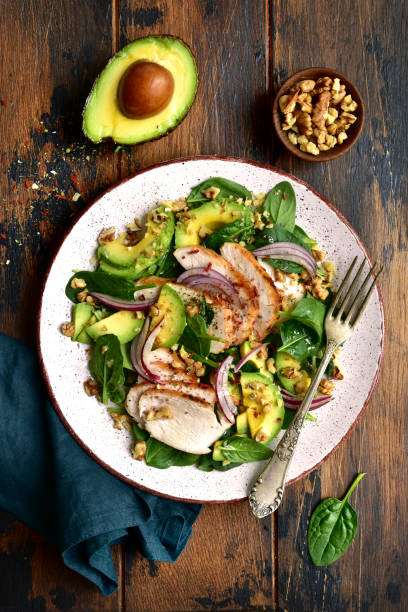 istock Spinach salad with grilled chicken fillet, avocado and walnuts 1132622268