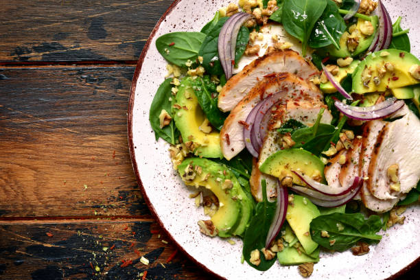 istock Spinach salad with grilled chicken fillet, avocado and walnuts 1132622334