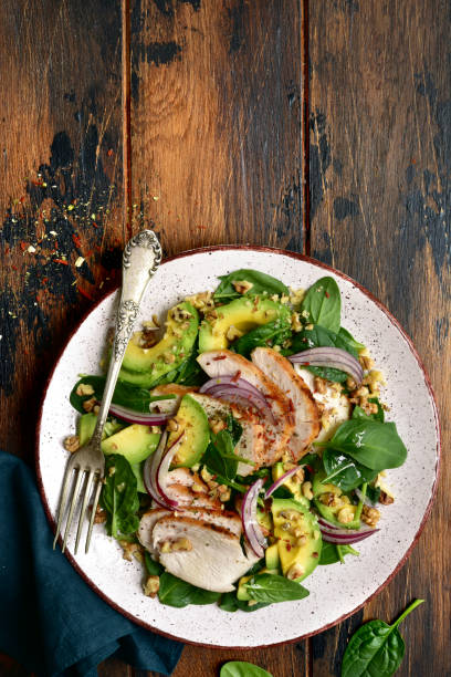 istock Spinach salad with grilled chicken fillet, avocado and walnuts 1132622357