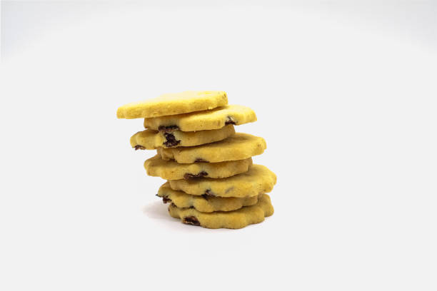 Crispy Raisin biscuits Piled on top of each other and on a white background.
