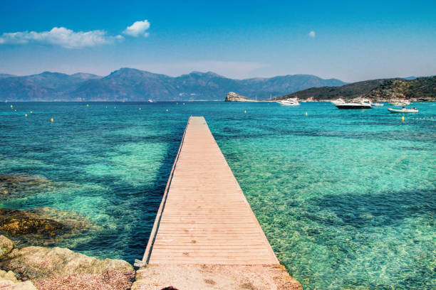 Corsica - The Isle of Beauty, France Pontoon at the Lotu beach, Agriates desert, Corsica - The Isle of Beauty, France jetty stock pictures, royalty-free photos & images