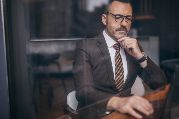istock Senior businessman with eyeglasses is working on laptop 1132625516