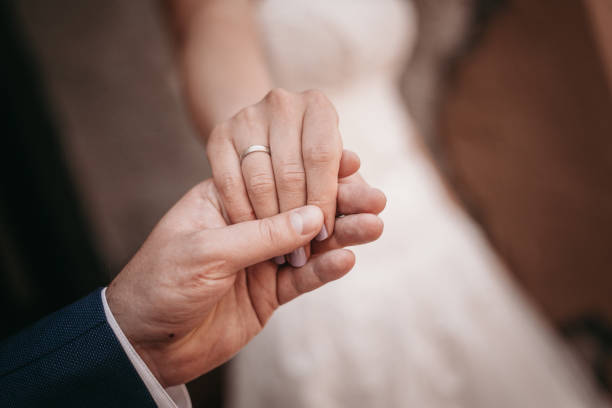 istock Holding hands - bride and groom 1132625662