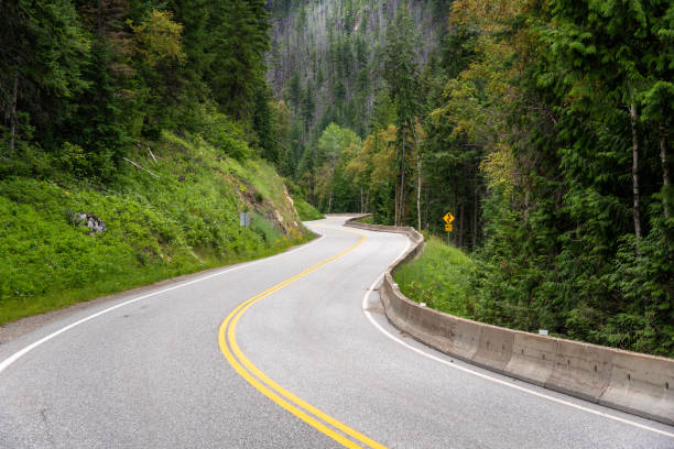 istock Deserted Winding Road in the Mountains in Summer 1132642572