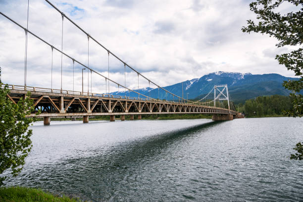 istock Highway Bridge Over a Wide River in the Mountains on a Cloudy Summer Day 1132642835