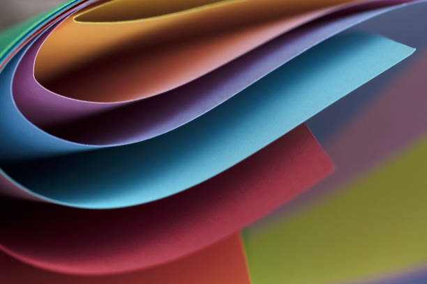 istock Abstract colored papers on blue, pink and orange background. 1132643611