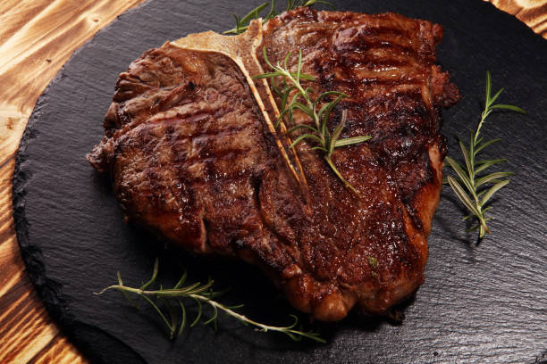 istock Grilled T-bone steak on stone cutting board. 1132643731