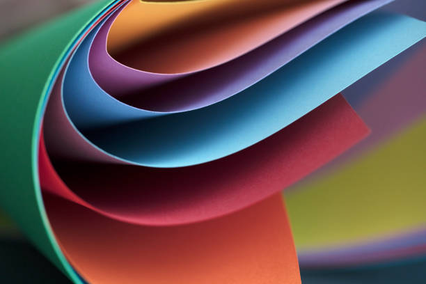 istock Abstract colored papers on blue, pink and orange background. 1132643925