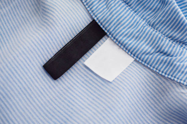 istock blank black and white clothing label on blue fabric texture background 1132644948