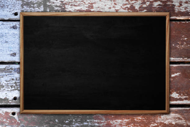 istock Abstract blackboard or chalkboard with frame on wooden background. 1132645024