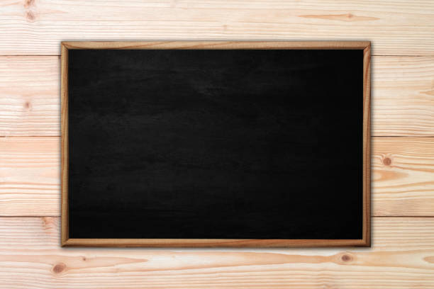 istock Abstract blackboard or chalkboard with frame on wooden background. 1132645027