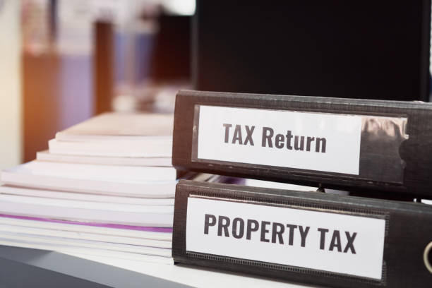 istock Property tax and tax return word on folders stack with label black binder on paperwork documents summary report in busy offices. HR-human resources business bookkeeping accountancy Document Concept 1132646190