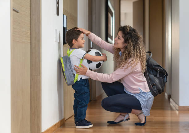 istock Mother saying goodbye to her son before he goes to school 1132647568