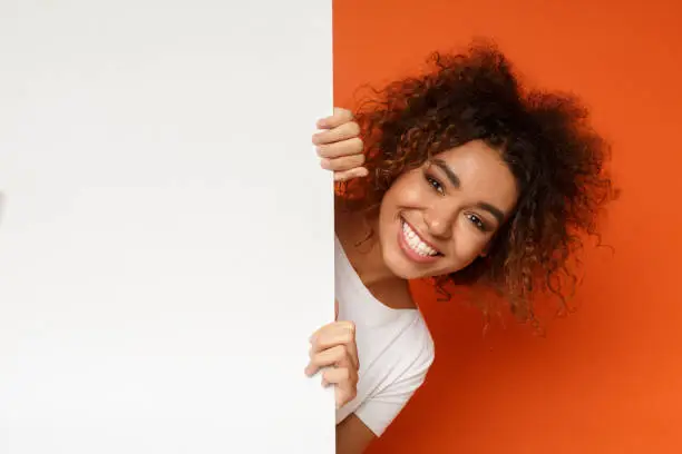 Photo of Black woman looking out of white blank card