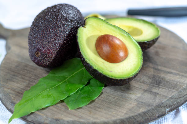 istock Two ripe raw hass avocados close up 1132649659