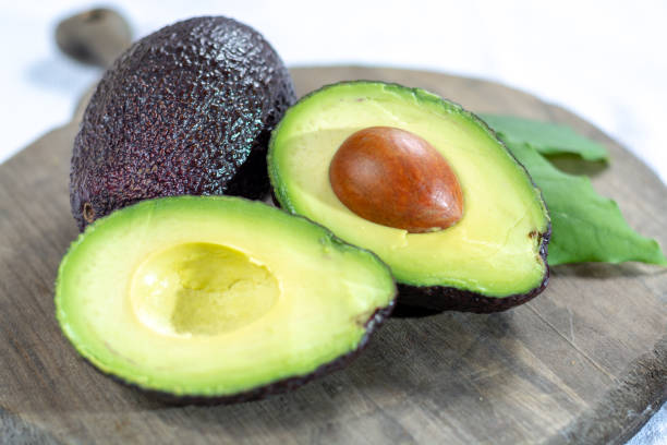 istock Two ripe raw hass avocados close up 1132649669