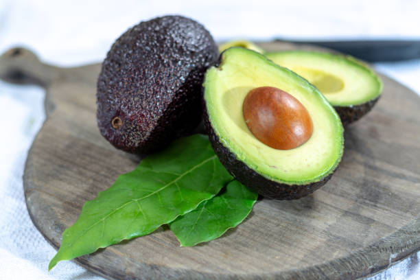istock Two ripe raw hass avocados close up 1132649672