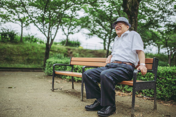 istock Elderly men resting at the park bench 1132652490