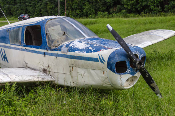 istock Close up of blue and white abandoned single prop plane left in grass 1132654291