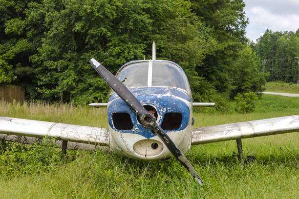 istock Front of an abandoned single prop blue and white plane in a grass field 1132654892