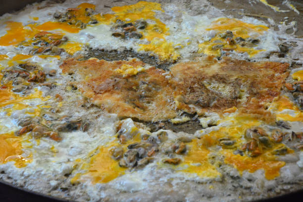 istock oysters fried in egg batter on the pan 1132655083