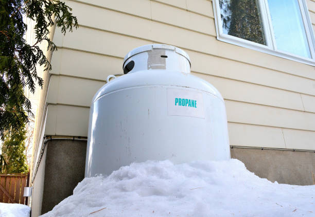 Lifestyle, " A Large Propane Fuel Tank " Lifestyle, This shot shows a large propane fuel tank behind a residential building. The gas is  used as fuel for home heating. propane stock pictures, royalty-free photos & images