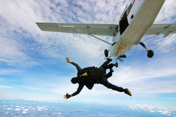 Skydiving tandem jump out of plane Skydive tandem jump jet stock pictures, royalty-free photos & images