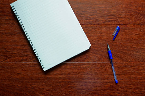 istock A note book, pen and some leaves decoration. 1132659062