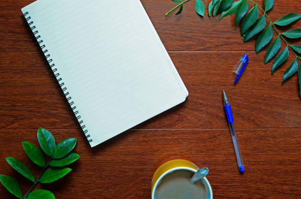 istock A note book, pen and some leaves decoration. 1132659069