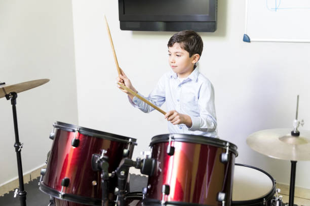 istock Boy Enhancing Drum Playing Skills In Music School 1132660255